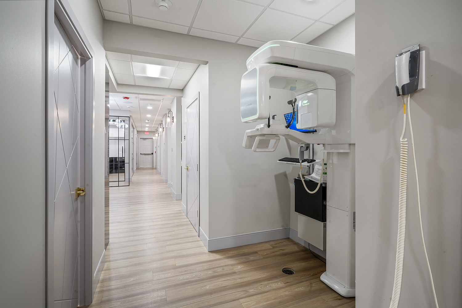 The image shows an interior space that appears to be a medical facility, with a large piece of medical equipment prominently displayed in the foreground.