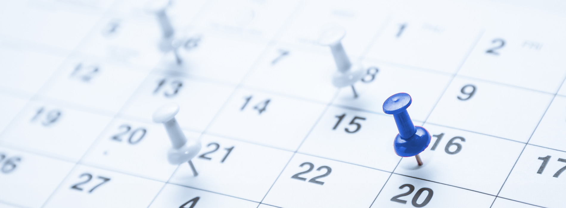 The image shows a calendar with dates and blue pins, indicating events or tasks scheduled for specific days.