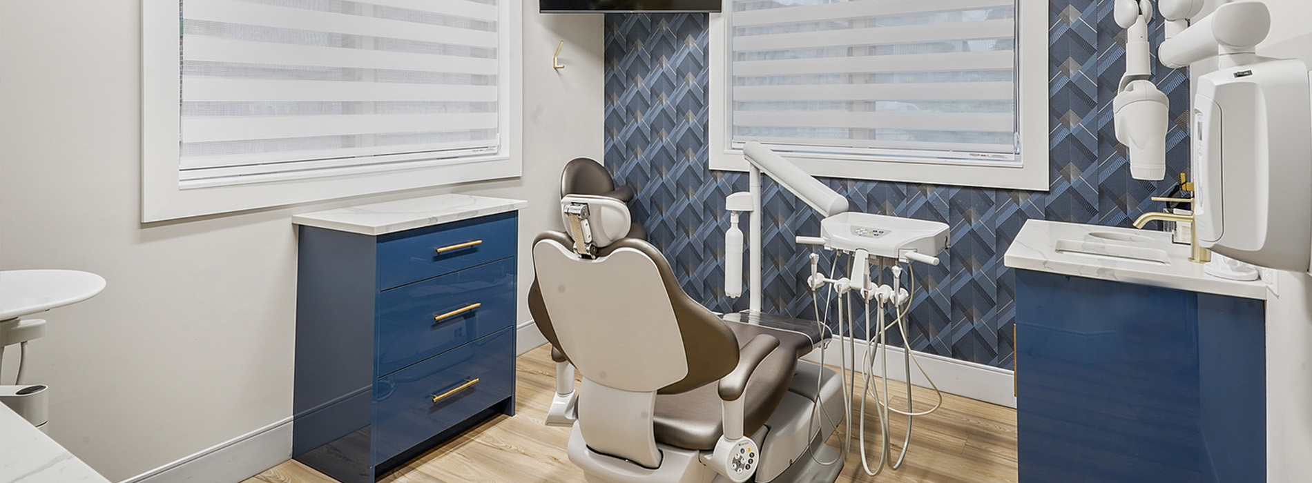 A modern dental office interior with a blue color scheme.