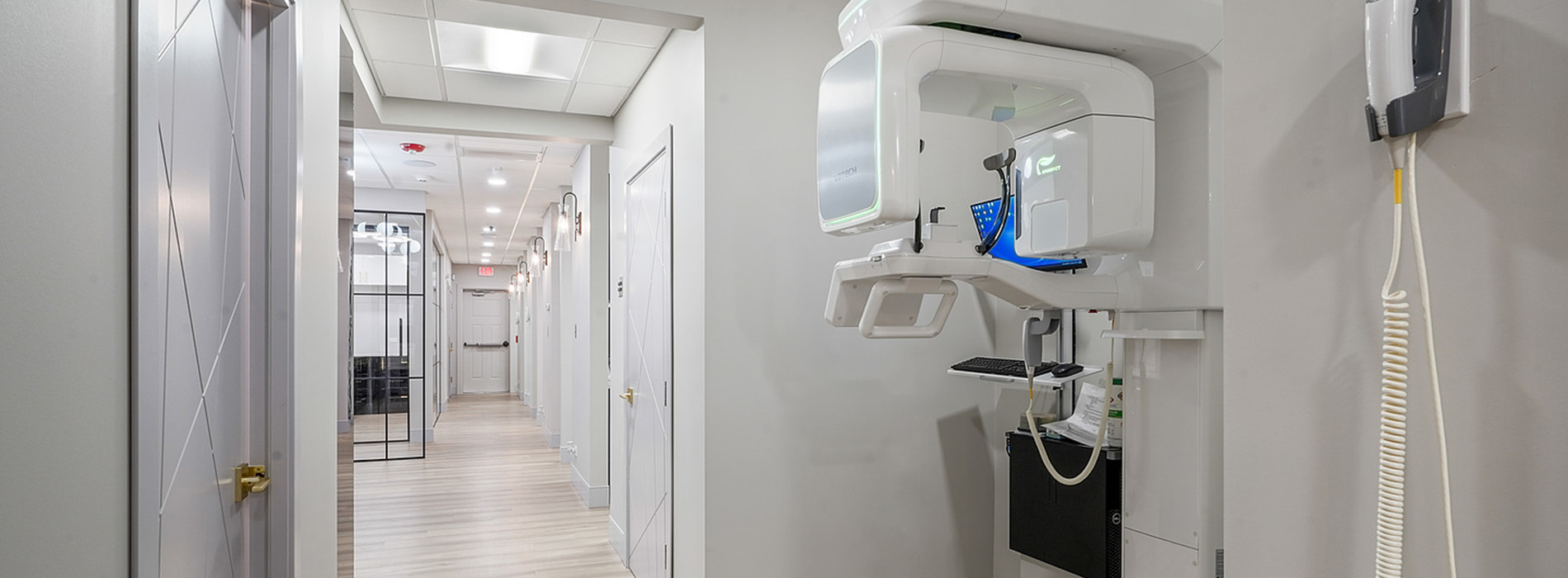 The image shows an interior view of a medical facility, specifically a dental office, with a modern and clean design.