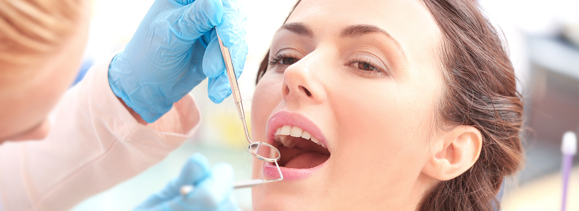 Dental hygienist performing a dental cleaning procedure on a patient s teeth.