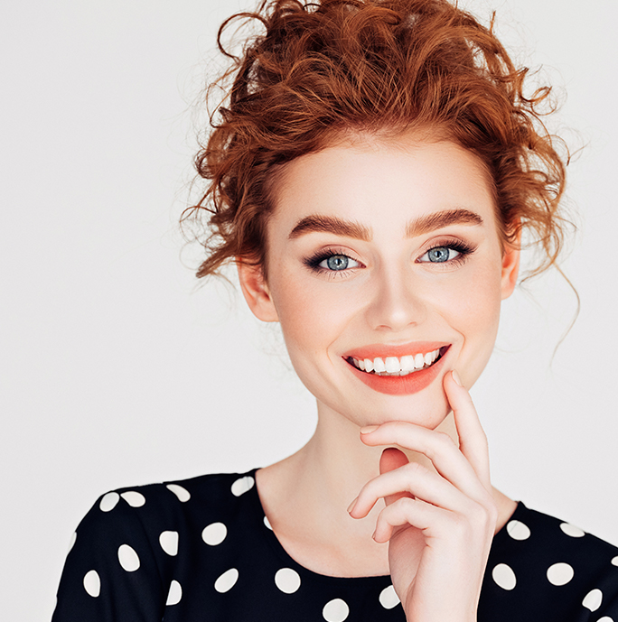 Redhead woman smiling with white teeth