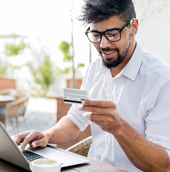 Man with glasses online shopping with his credit card